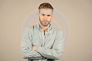 Bearded man keep arms crossed on grey background. Macho with serious face. Tired after everyday work. Office dress code