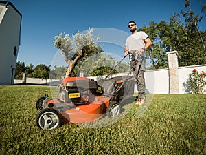 Bearded man with a lawnmower