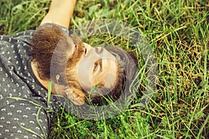 Bearded man laying on green grass