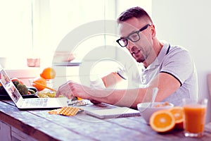 Bearded man leading healthy lifestyle studying info about food supplements