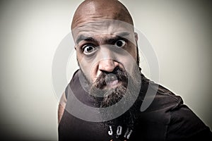 Bearded man looking camera with funny strange expression