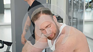 Bearded man looking at muscles in cycling class