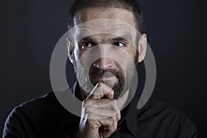 Bearded man looking thoughtful and reflective.