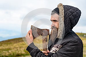 bearded man lumberjack with sharp axe. photo of bearded man lumberjack holding axe