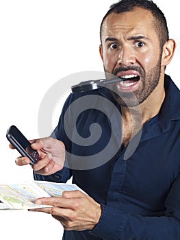 Bearded man with map, cell phone, magnifying glass