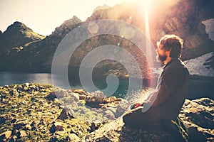 Bearded Man meditating relaxing alone Travel healthy Lifestyle concept