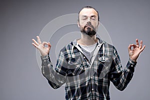 Bearded man meditating with a serene expression