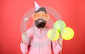 Bearded man with party accessories, surprise concept. Man with paper lips, enormous crazy glasses and balloons isolated