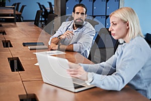 Bearded man peeping at the laptop screen