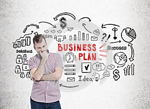 Bearded man in pink shirt and business plan