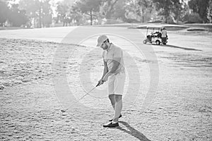 bearded man playing golf game on green grass, hobby