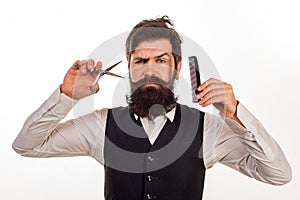 Bearded man, portrait of man with long beard and moustache. Barber scissors and comb for barber shop. Vintage barbershop