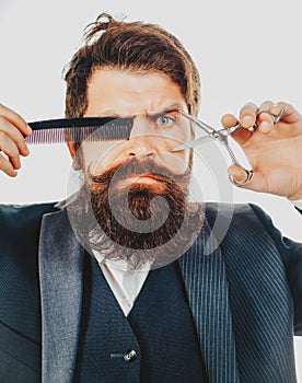 Bearded man, portrait of man with long beard and moustache. Retro barber scissors and comb for barber shop. Vintage