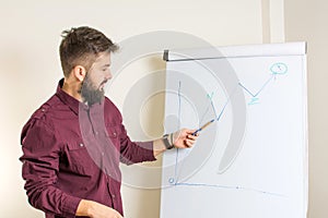 Bearded man presenting by the flipchart