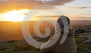 Bearded Man reaching the destination and on the top of mountain at sunrise or sunset on cold day Travel Lifestyle concept The