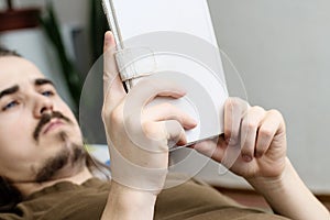 Bearded man reading ebook