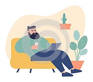 Bearded man relaxing on couch with laptop and coffee. Casual male enjoys leisure time indoors. Comfortable home setting