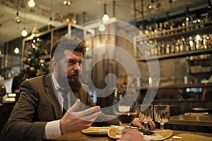 Bearded man in restaurant with companion. Business on go and communication. Confident bar customer speak in cafe. Date