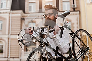 Bearded man with retro bicycle.