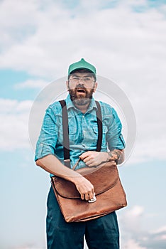 Bearded man with retro briefcase. Mature hipster with beard. Brutal male. Vintage fashion bag. Bearded man. Going to