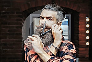 Bearded man with scissors. Barber scissors and straight razor, barber shop, suit. Vintage barber shop, shaving. Portrait