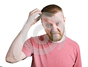 Bearded man scratches his head hair