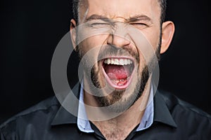 Bearded man screaming photo