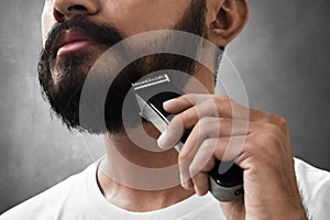 Bearded man shaving his beard