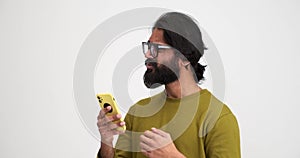 Bearded man shocked on receiving bad news over mobile phone