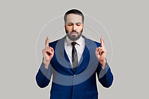 Bearded man showing time out gesture, looking with imploring eyes, hurry to meet deadline.