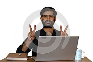 A bearded man showing victory sign with both hands