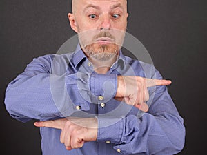 Bearded man shows his index fingers in different directions