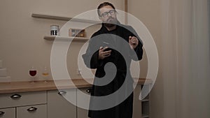 Bearded man with smartphone dancing