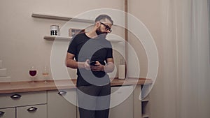 Bearded man with smartphone dancing