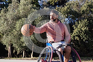 Bearded man in sports wheelchair dribbling basketball