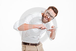 Bearded man standing over white wall background