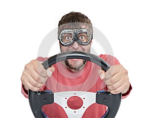 Bearded man in stylish goggles with steering wheel isolated on white background, car driver concept