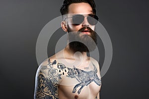 Bearded Man in sunglasses, naked tattoed Boy