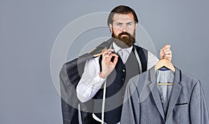 bearded man tailoring clothes. formal and office wardrobe. businessman. confident tailor designing male jacket. handsome