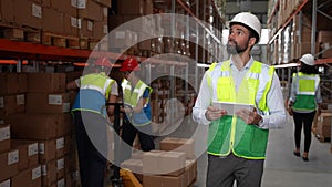 Bearded man taking inventory of goods in warehouse