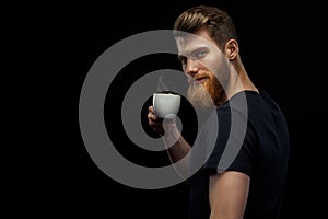 Bearded man is tasting coffee photo