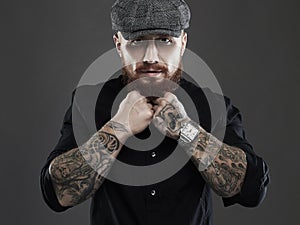 Bearded man with tattoo..brutal handsome man in hat photo