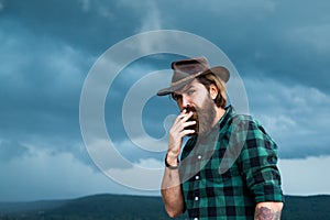 Bearded man. texas brutal cowboy. brutal hipster with moustache in hat. fashion model wear casual west clothes. male