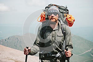 Bearded Man traveler hiking in mountains