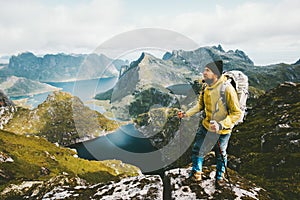 Bearded man traveler standing on cliff mountain