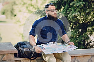 Bearded man travels with map