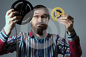 Bearded man with two film reel