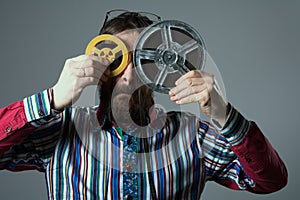 Bearded man with two 16mm film reel