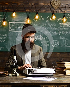 Bearded man type on vintage typewriter. Man with beard typewrite research paper. Businessman in suit work at desk