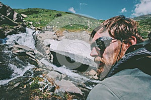 Bearded Man wearing mountain sunglasses hiking Travel Lifestyle concept adventure